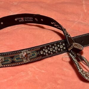 Brown leather belt with cross and multicolored background accents